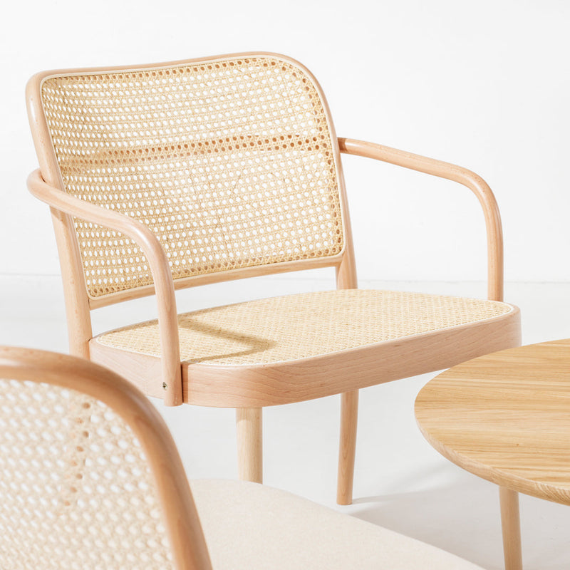 Light wood armchair with woven rattan seat and back, featuring a natural finish and minimalistic design.