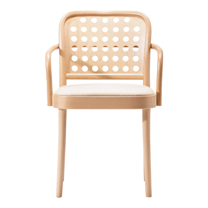 Light wood dining chair with a cream cushioned seat and playful circular cut-out pattern on the backrest.