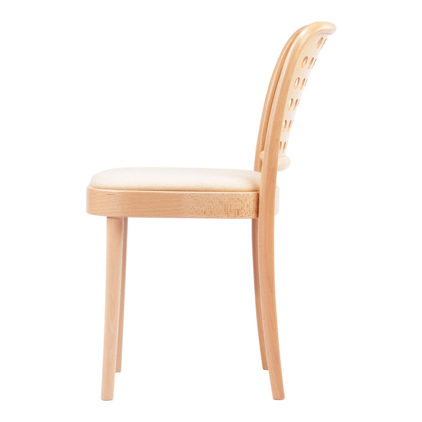 Light wood chair with a smooth beige seat and curved backrest featuring circular cutout patterns.