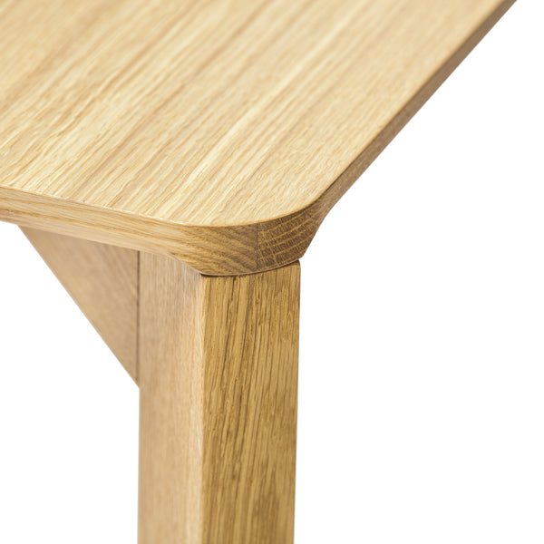 Light oak wood tabletop with natural grain pattern, featuring smooth rounded edges and matching legs.