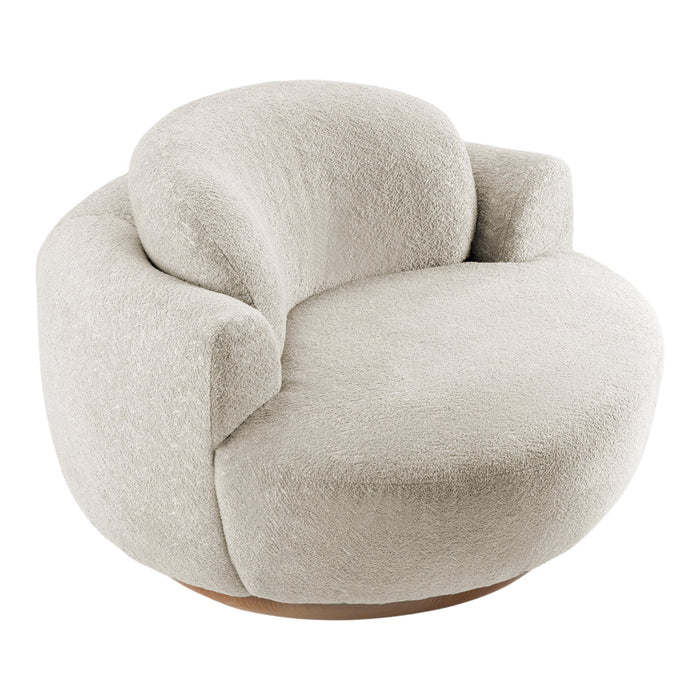 Curved, plush armchair featuring a soft cream color and texture, perfect for modern decor.