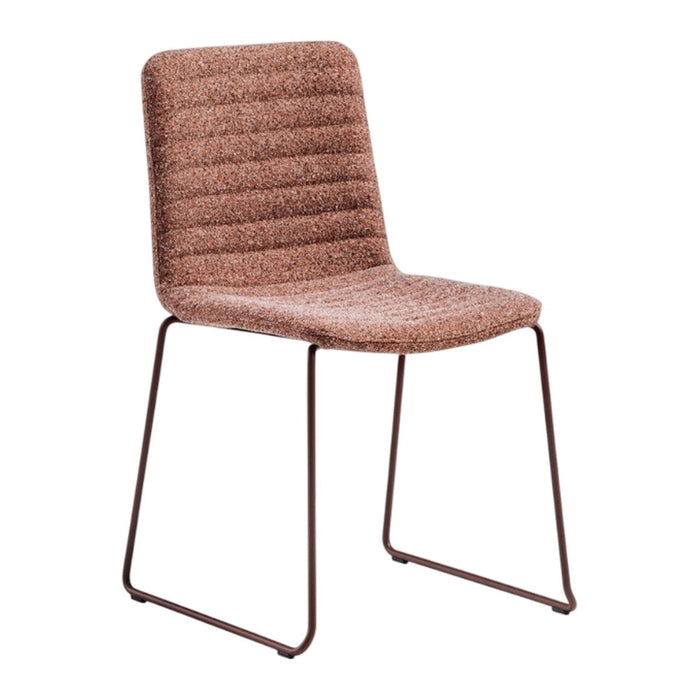 Rust-colored ribbed chair with a sleek metal frame, perfect for modern decor. Versatile and stylish seating solution.