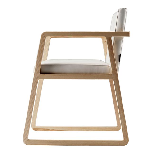 Minimalist wooden chair with a natural finish and a white cushion, showcasing a contemporary design.