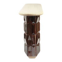 Brown faceted column base with a smooth cream top, showcasing a modern geometric design and sleek finish.