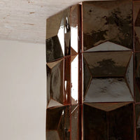 Glossy brown geometric tiles with a faceted pattern, reflecting light, perfect for modern home decor.