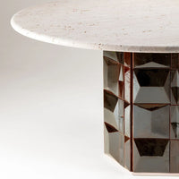 Round white tabletop with a textured, glossy geometric brown base. Elegant and modern design featuring contrasting colors.