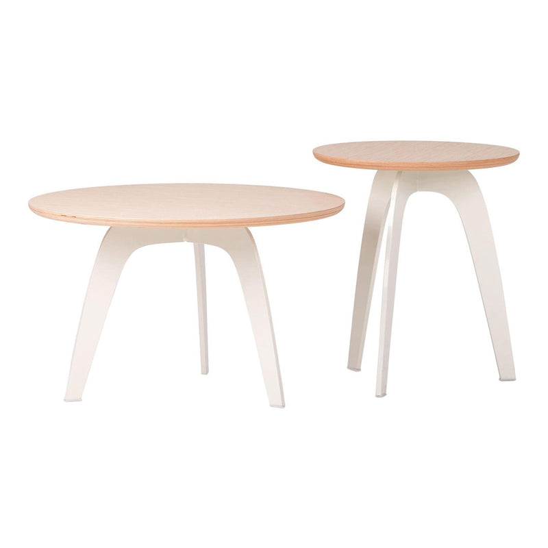 Set of two round tables in soft peach tops and white legs, featuring a sleek and modern design.