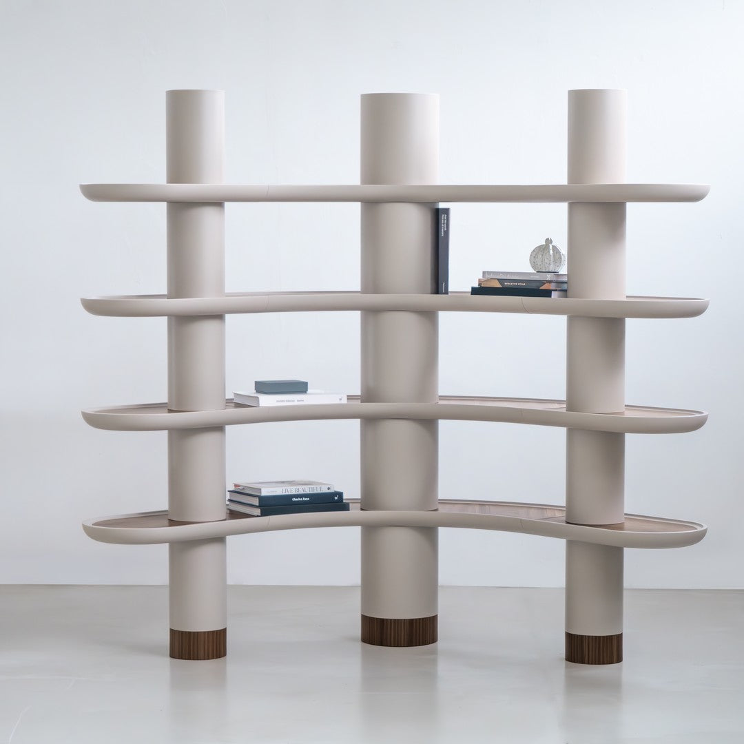 Modern beige bookshelf with smooth, curved shelves and brown base accents, perfect for contemporary decor.