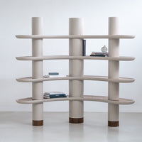 Modern beige bookshelf with smooth, curved shelves and brown base accents, perfect for contemporary decor.