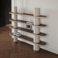 Modern shelving unit with curved light wood shelves and cylindrical white supports, contrasting with a dark herringbone floor.