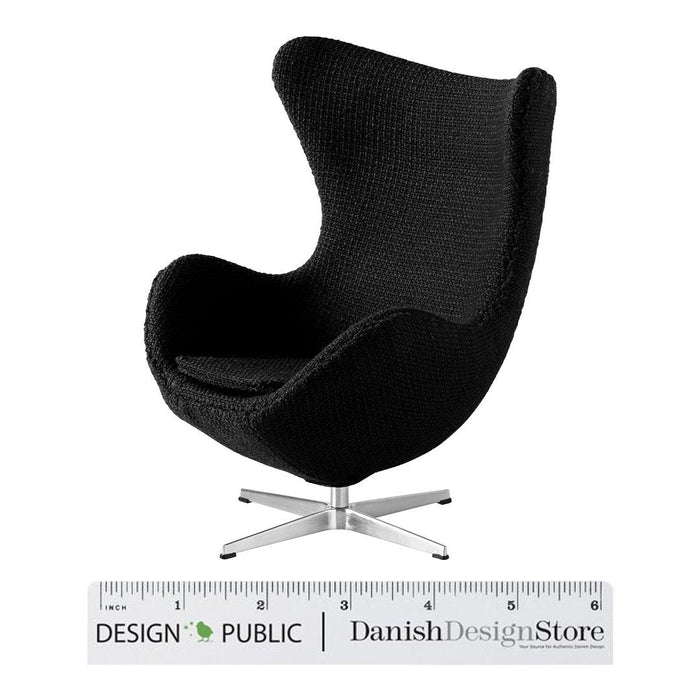 Black upholstered modern chair with a sleek, minimalist design and a polished silver base. Perfect for stylish interiors.
