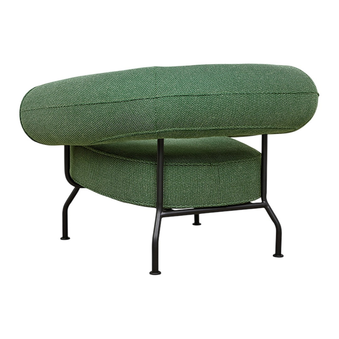Green upholstered chair with a rounded design and black metal legs, featuring a textured fabric pattern.