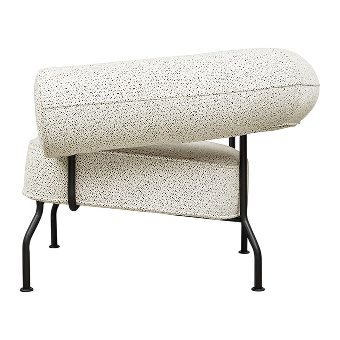 Stylish chair with a speckled white upholstery and black metal frame, showcasing a modern and minimalist design.