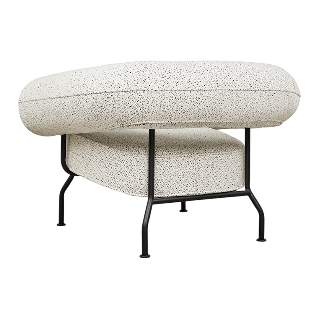 Textured white upholstery with black speckles, supported by a minimalist black metal frame.
