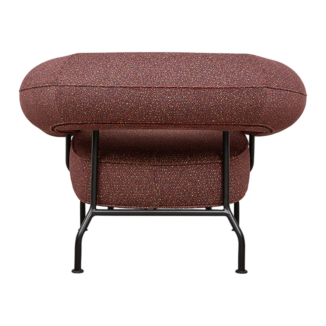 Textured burgundy pouf with colorful speckles, supported by a sleek black metal frame. Modern and vibrant design.