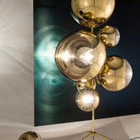 Gold reflective orbs with a striking geometric pattern against a dark blue and light backdrop.
