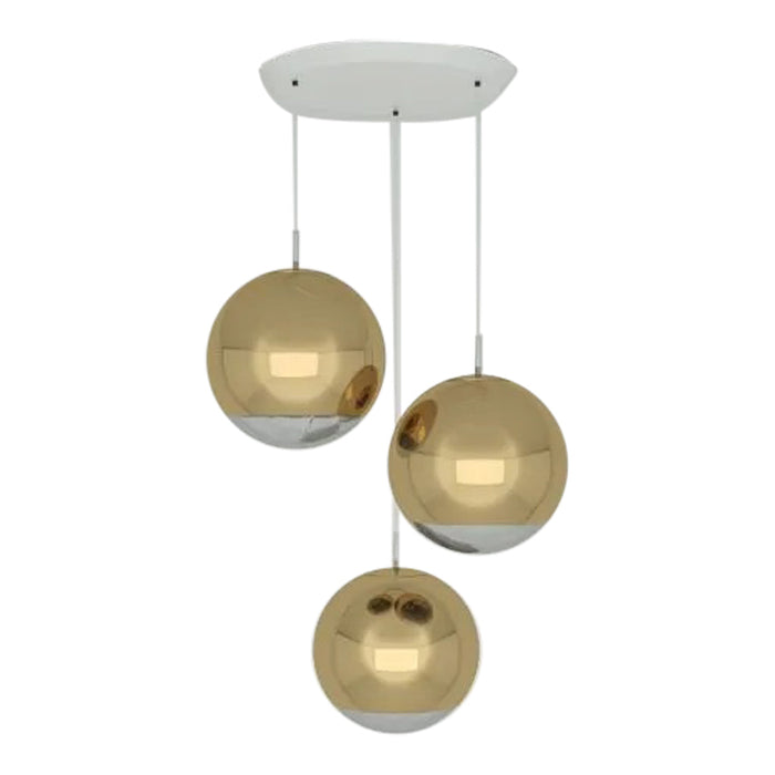 Three hanging pendant lights featuring gold and chrome spherical shades with a sleek white mount.