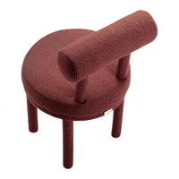 Round burgundy chair with textured fabric and a unique cylindrical backrest design, perfect for modern decor.