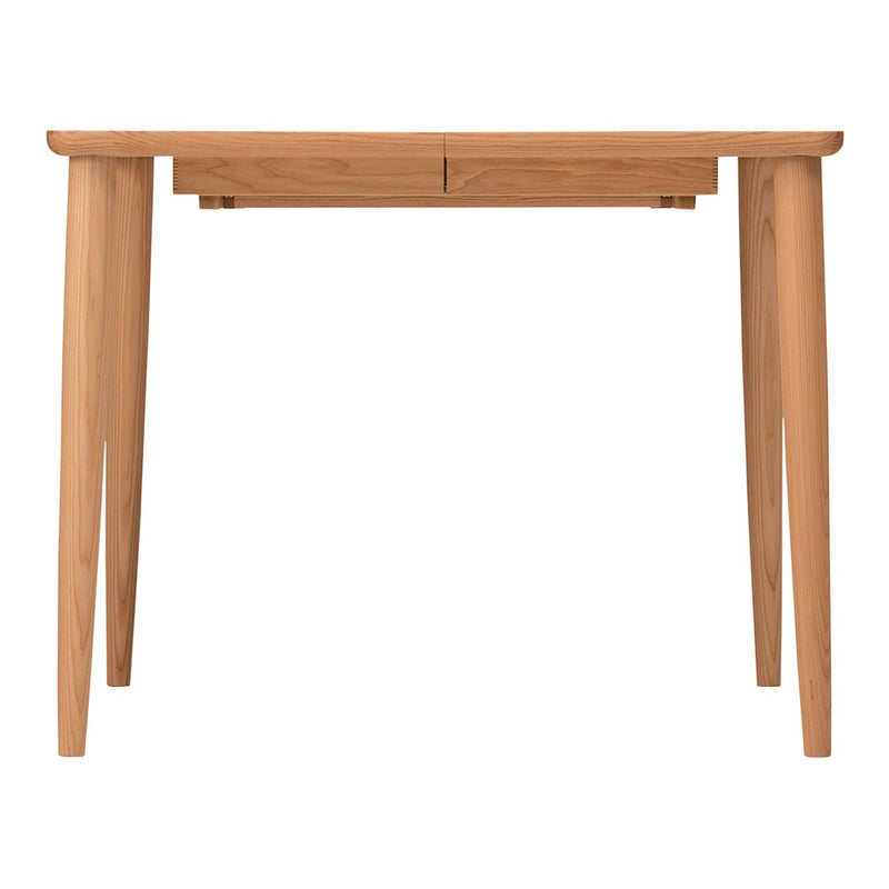 Natural wood dining table with a light tan finish and clean, minimalist lines. Perfect for modern interiors.
