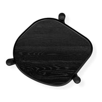 Black wood table with a unique asymmetrical shape and subtle grain pattern, featuring rounded black legs.