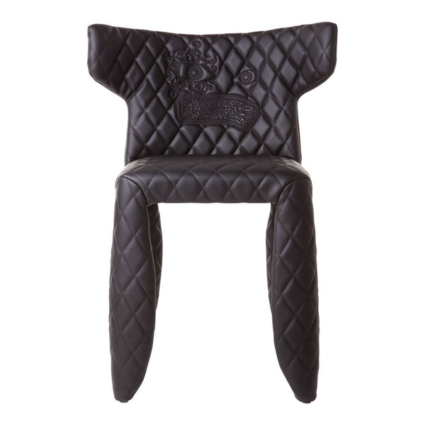 Black chair with diamond quilted pattern and unique design details, adding elegance to any decor.