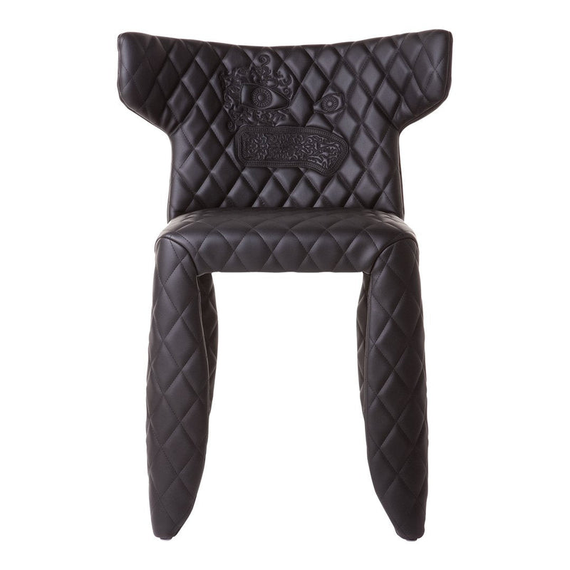Black chair with diamond quilted pattern and unique design details, adding elegance to any decor.