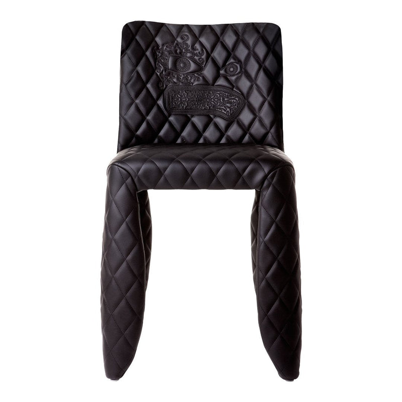 Black quilted chair featuring a diamond pattern and embossed design, adding a touch of elegance to any space.