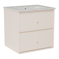 Light pink storage cabinet with a speckled gray top and two drawers. Modern minimalist design and neutral colors.