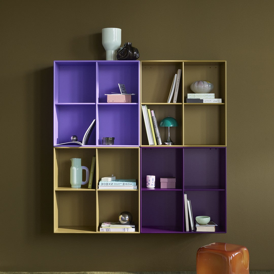 Colorful geometric bookshelf in purple and beige with decorative items against a brown wall.