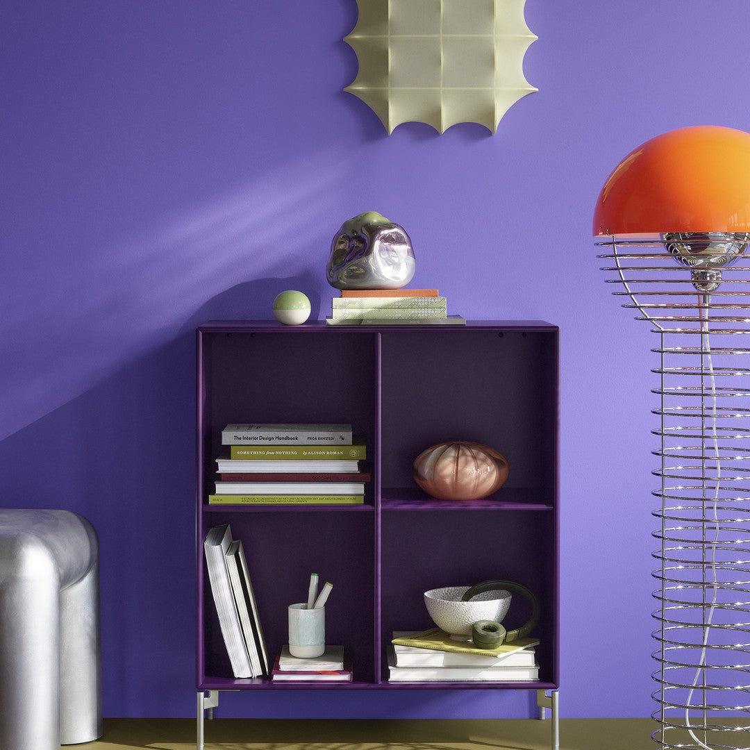 Purple shelving unit against a vibrant violet wall, featuring mixed patterns and colorful decor accents.