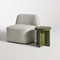 Light gray textured chair with a smooth olive green side table. Modern and minimalist design.