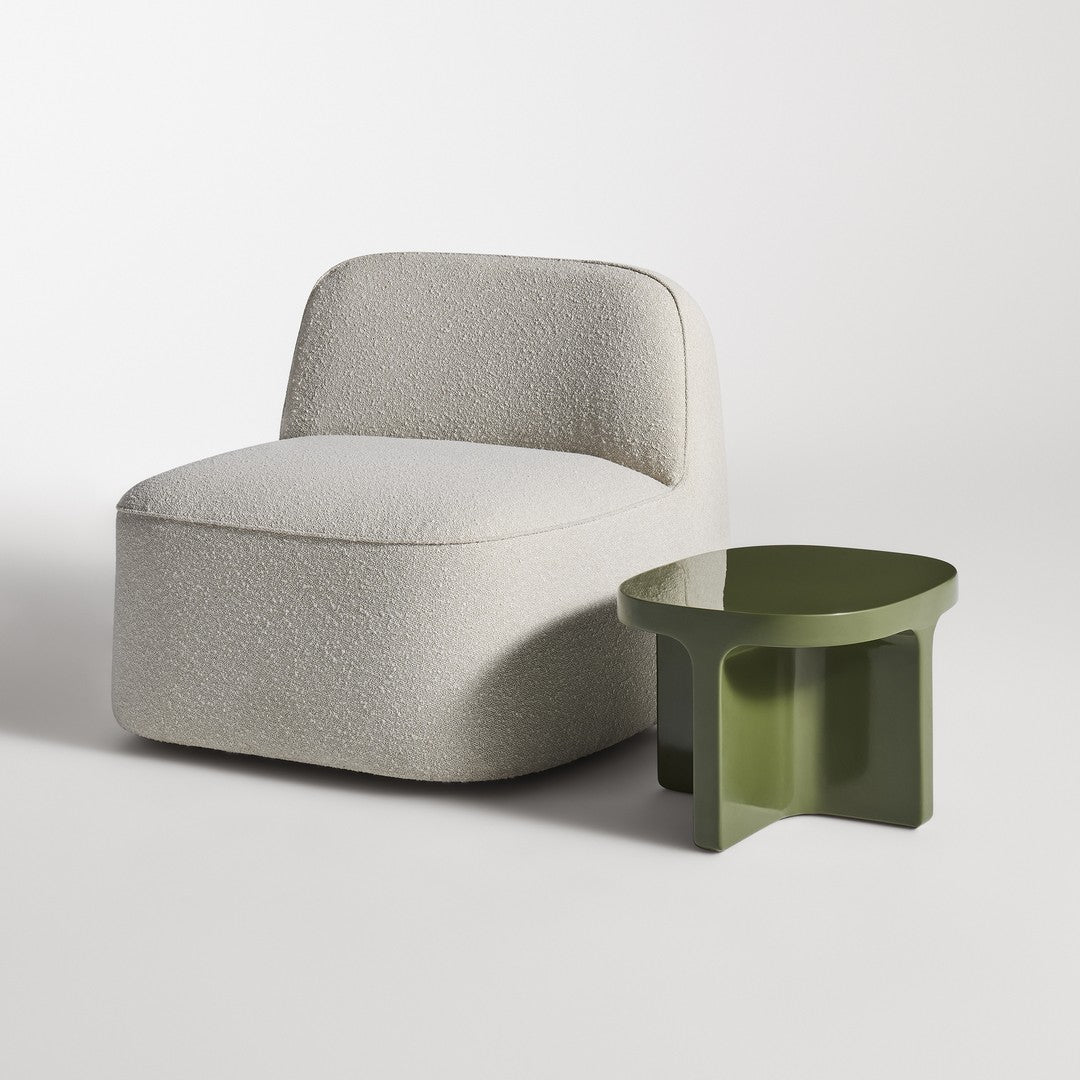 Light gray textured chair beside a modern olive green side table against a minimalist white backdrop.