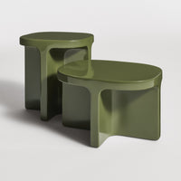 Two modern side tables in a sleek olive green finish with smooth, minimalistic shapes and no visible patterns.