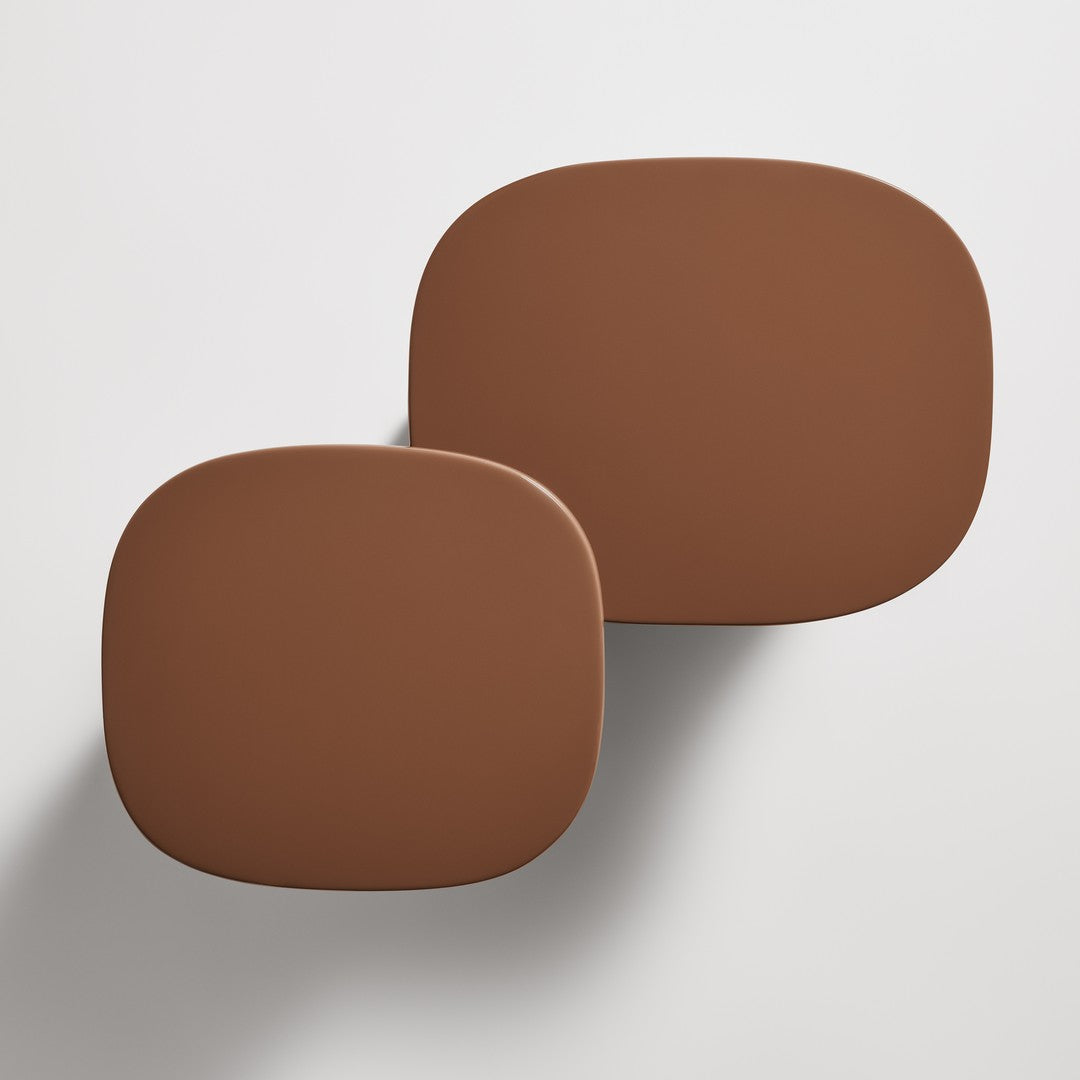 Two brown abstract-shaped trays with smooth, matte surfaces, showcasing a rich, warm color palette.