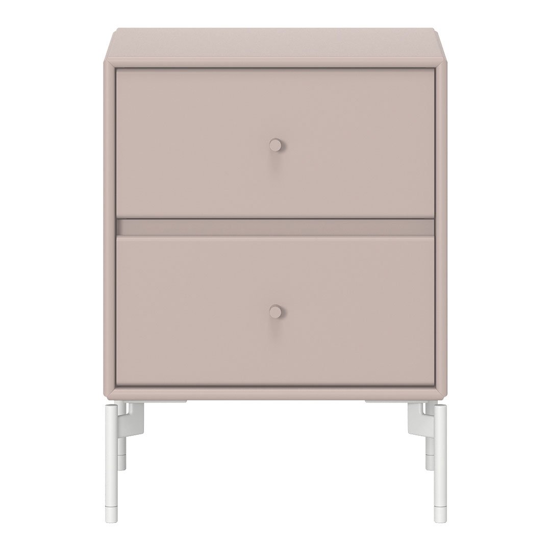 Blush pink nightstand with minimalist design and sleek white legs, featuring smooth finish and subtle round knobs.