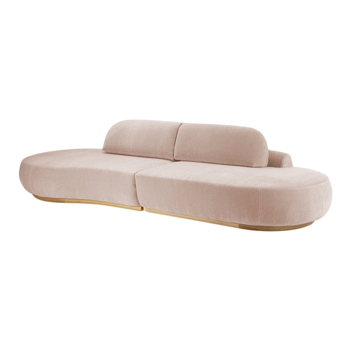 Soft pink curved sofa with a sleek design, featuring smooth upholstery and natural wood accents.