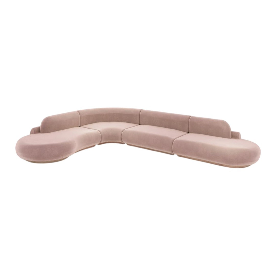 Soft pink curved sectional sofa with a smooth texture and subtle, contemporary design. Ideal for modern living spaces.