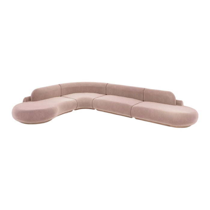 Soft pink curved sectional sofa with a smooth texture and subtle, contemporary design. Ideal for modern living spaces.