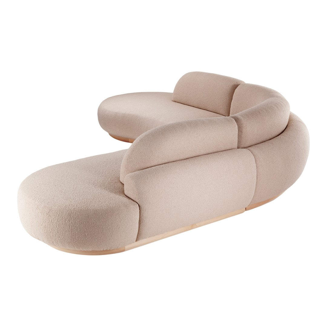 Beige curved sofa with soft contours and a minimalist design, featuring a textured upholstery pattern.