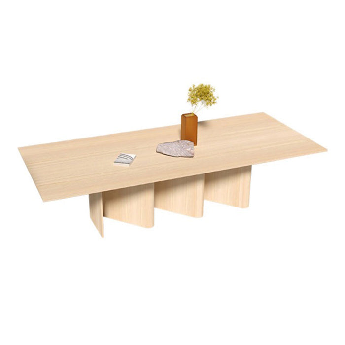 Light beige rectangular table with a smooth finish and minimalist design, featuring natural wood grain patterns.