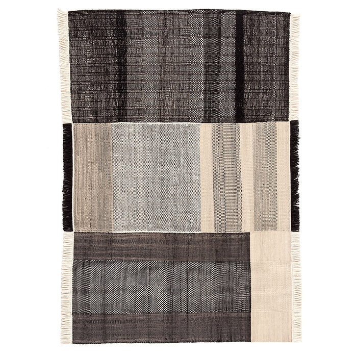 Textured area rug featuring a modern design in shades of black, gray, and beige with subtle woven patterns.