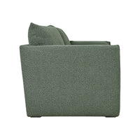 Side view of a textured green sofa with a subtle pattern, ideal for modern home decor.