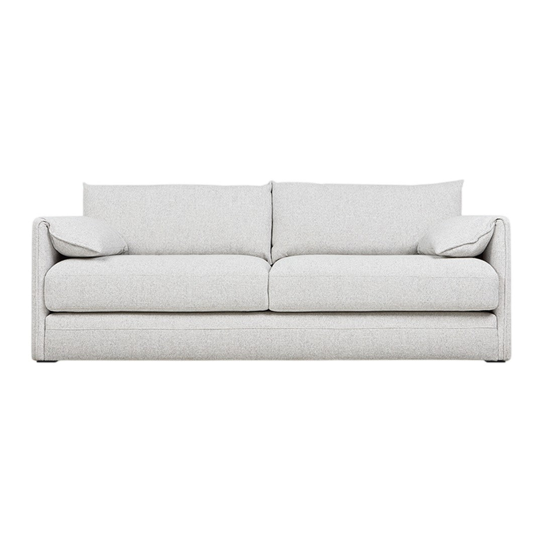Light gray sofa with a smooth, minimalist design and soft, plush cushions for a modern aesthetic.