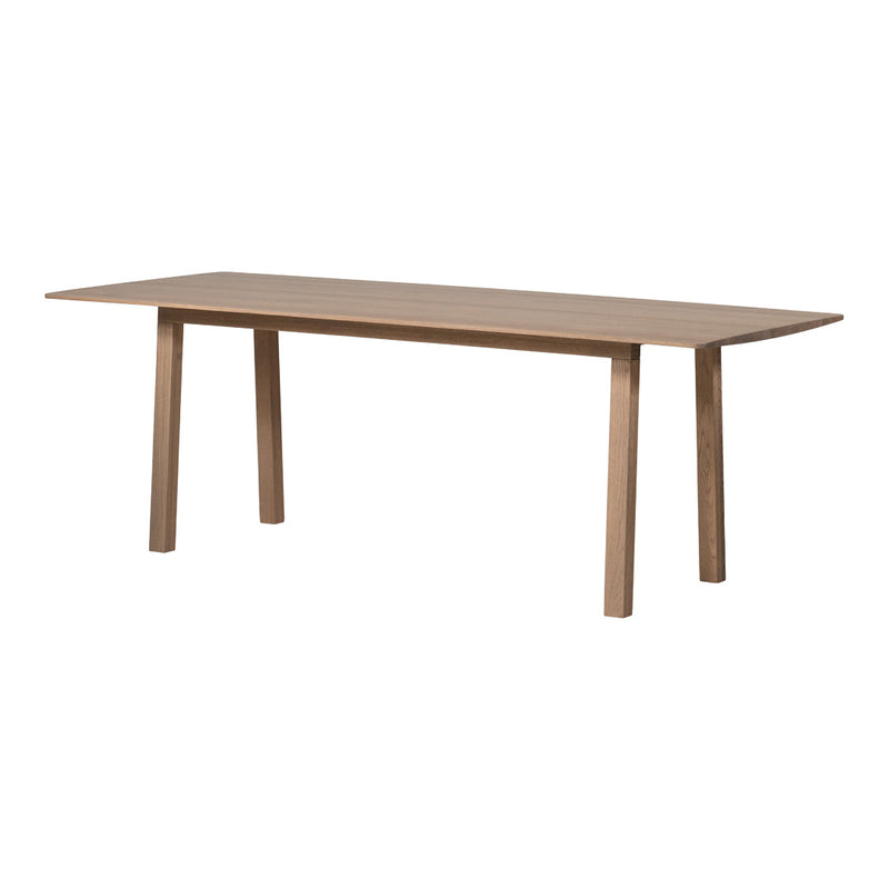 Long rectangular wooden table in a warm, natural brown finish with a smooth, minimalist surface and clean lines.