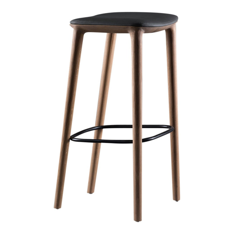 Modern black stool with sleek wood legs in a warm brown finish, featuring a minimalist design and simple black footrest.