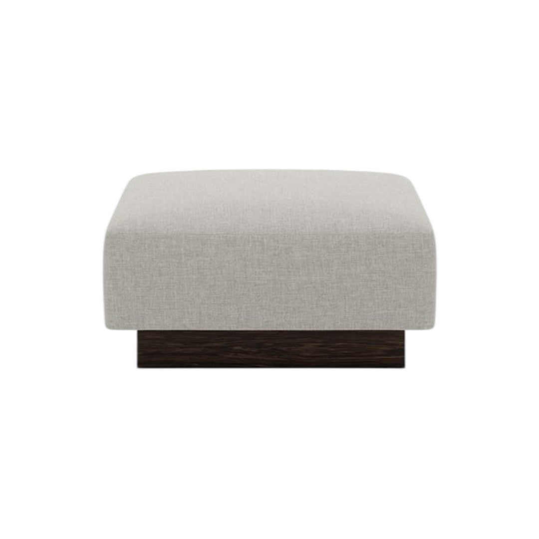 Light gray upholstered ottoman with a smooth texture and dark wooden base, featuring a modern, minimalist design.