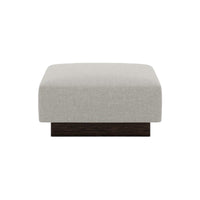 Light gray upholstered ottoman with a smooth texture and dark wooden base, featuring a modern, minimalist design.