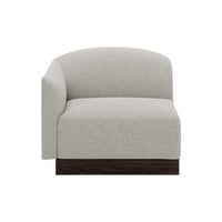 Light gray curved chair with textured fabric and dark wooden base, perfect for modern decor.
