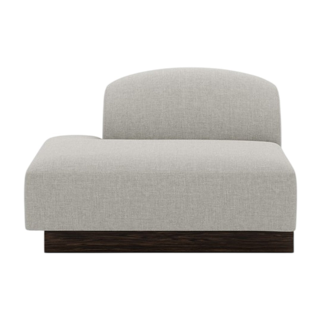 Light gray upholstered chaise lounge with a smooth fabric texture and a dark wood base. Modern, minimalist design.