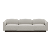 Light gray upholstered sofa with rounded cushions and a dark wood base, featuring a minimalist design.